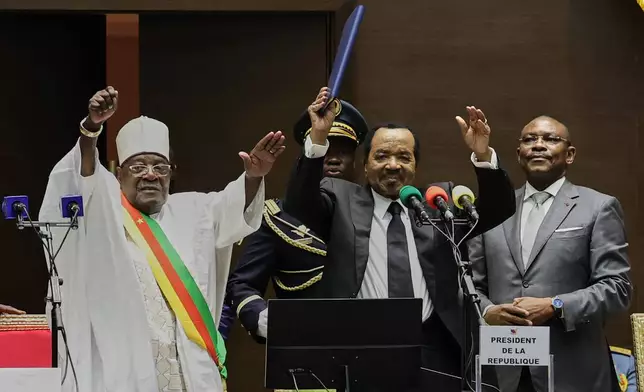 Cameroon's President Paul Biya, second from right, raises his hand after being sworn in for a new term during his inauguration ceremony at the National Assembly in Yaounde, Cameroon, Thursday, Nov. 6, 2025. (AP Photo/Angel Ngwe)