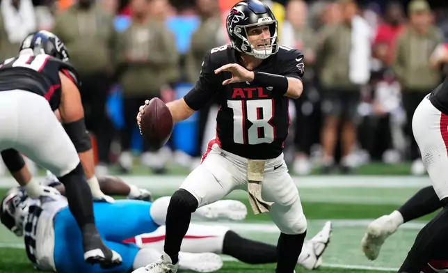 Atlanta Falcons quarterback Kirk Cousins (18) scrambles against the Carolina Panthers in the second half of an NFL football game, Sunday, Nov. 16, 2025, in Atlanta. (AP Photo/Brynn Anderson)