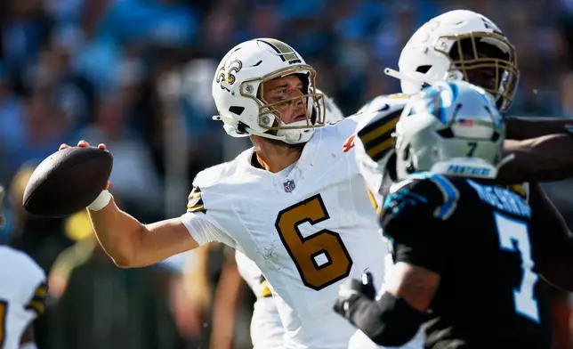 New Orleans Saints quarterback Tyler Shough passes for a touchdown against the Carolina Panthers during the first half of an NFL football game, Sunday, Nov. 9, 2025, in Charlotte, N.C. (AP Photo/Rusty Jones)