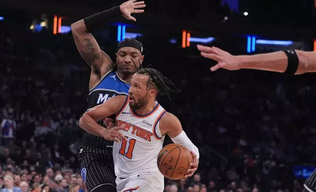 New York Knicks' Jalen Brunson (11) drives past Orlando Magic's Wendell Carter Jr. (34) during the first half of an NBA basketball game Wednesday, Nov. 12, 2025, in New York. (AP Photo/Frank Franklin II)