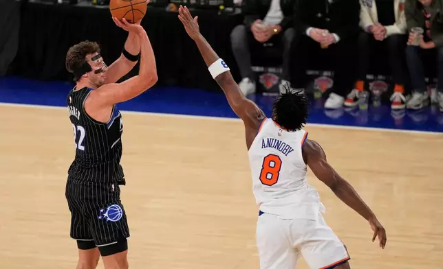 Orlando Magic's Franz Wagner (22) shoots over New York Knicks' Og Anunoby (8) during the second half of an NBA basketball game Wednesday, Nov. 12, 2025, in New York. (AP Photo/Frank Franklin II)