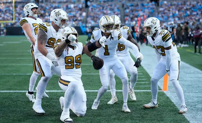 New Orleans Saints cornerback Alontae Taylor celebrates intercepting a pass intended for Carolina Panthers wide receiver Tetairoa McMillan during the second half of an NFL football game, Sunday, Nov. 9, 2025, in Charlotte, N.C. (AP Photo/Jacob Kupferman)