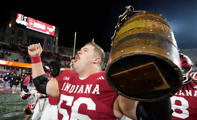 FILE - Indiana's Mike Katic celebrates with the Old Oaken Bucket after defeating Purdue in an NCAA college football game, Saturday, Nov. 30, 2024, in Bloomington, Ind. (AP Photo/Darron Cummings, File)