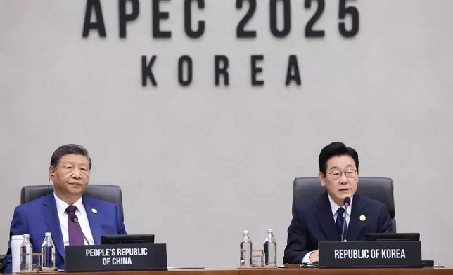 South Korean President Lee Jae Myung, right, speaks next to Chinese President Xi Jinping at the Asia-Pacific Economic Cooperation (APEC) Economic Leaders' Meeting in Gyeongju, South Korea, Saturday, Nov. 1, 2025. (Yonhap via AP)