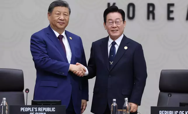 Chinese President Xi Jinping shakes hands with South Korean President Lee Jae Myung, at the Asia-Pacific Economic Cooperation (APEC) Economic Leaders' Meeting in Gyeongju, South Korea, Saturday, Nov. 1, 2025. (Yonhap via AP)