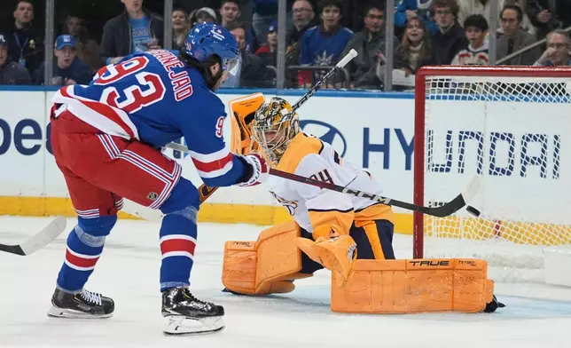 New York Rangers' Mika Zibanejad (93) shoots the puck past Nashville Predators goaltender Juuse Saros (74) during the first period of an NHL hockey game Monday, Nov. 10, 2025, in New York. (AP Photo/Frank Franklin II)