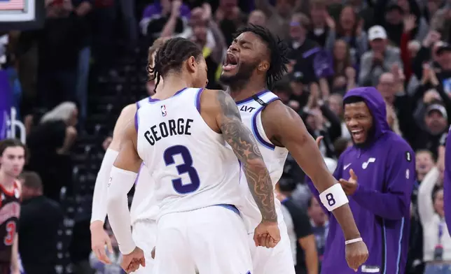 Utah Jazz guard Keyonte George (3) celebrates a three-point basket that sealed their win over the Chicago Bulls with guard Isaiah Collier, right, during the second overtime of an NBA basketball game, Sunday, Nov. 16, 2025, in Salt Lake City. (AP Photo/Rob Gray)