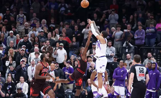 Utah Jazz guard Keyonte George (3) makes a three-point basket over Chicago Bulls guard Ayo Dosunmu to take the lead in the last seconds of the second overtime of an NBA basketball game, Sunday, Nov. 16, 2025, in Salt Lake City. (AP Photo/Rob Gray)