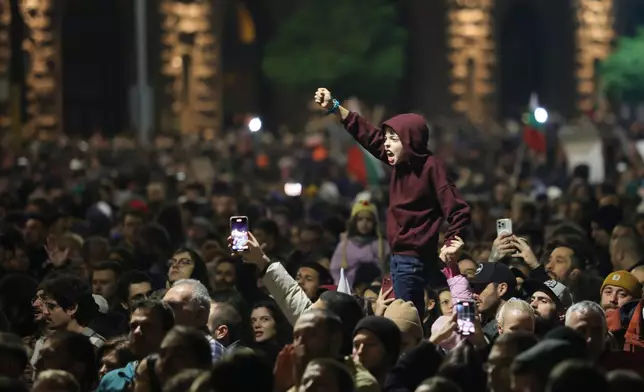 A young protester shouts anti-government slogans as thousands took to the streets of Bulgaria's capital, Sofia, to denounce steep tax hikes in next year's draft budget before being finally voted on in parliament, Wednesday, Nov 26, 2025. (AP Photo/Valentina Petrova)