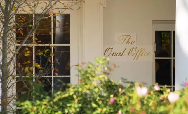 A sign is seen outside the Oval Office before President Donald Trump walks out to board Marine One on the South Lawn of the White House, Wednesday, Nov. 5, 2025, in Washington. (AP Photo/Evan Vucci)