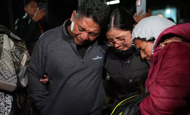 Relatives cry after receiving the remains of Maria Florinda Ríos Perez who was killed in Indiana, at La Aurora International Airport in Guatemala City, Sunday, Nov. 23, 2025. (AP Photo/Moises Castillo)