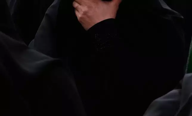 A mourner reacts during a funeral ceremony of unknown Iranian soldiers who were killed in the 1980-88 Iraq-Iran war whose remains were recently recovered from the battlefields, in Tehran, Iran, Monday, Nov. 24, 2025. (AP Photo/Vahid Salemi)