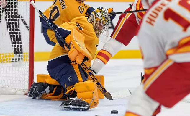Nashville Predators goaltender Juuse Saros (74) defends during the first period of an NHL hockey game against the Calgary Flames, Saturday, Nov. 1, 2025, in Nashville, Tenn. (AP Photo/Camden Hall)