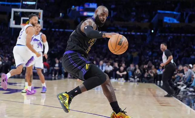 Los Angeles Lakers forward LeBron James (23) goes after a loose ball during the first half of an NBA basketball game against the Utah Jazz Tuesday, Nov. 18, 2025, in Los Angeles. (AP Photo/Jae C. Hong)