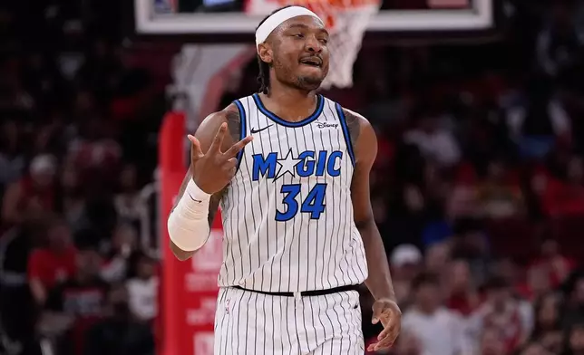 Orlando Magic center Wendell Carter Jr. reacts after making a 3-pointer during the first half of an NBA basketball game against the Houston Rockets in Houston, Sunday, Nov. 16, 2025. (AP Photo/Ashley Landis)