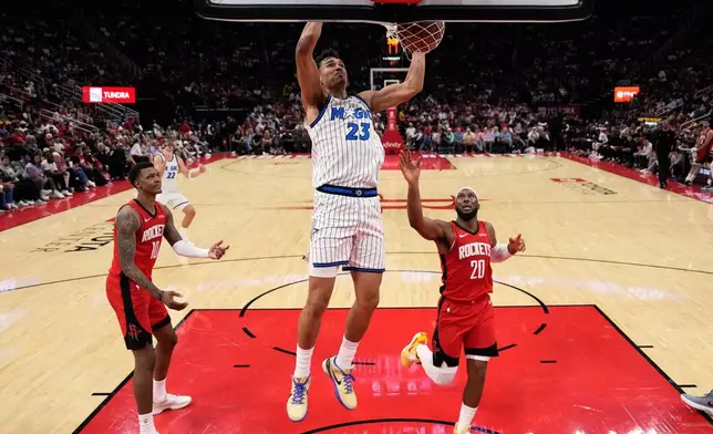 Orlando Magic forward Tristan da Silva (23) dunks during the first half of an NBA basketball game against the Houston Rockets in Houston, Sunday, Nov. 16, 2025. (AP Photo/Ashley Landis)