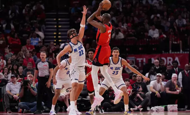 Houston Rockets forward Kevin Durant (7) shoots against Orlando Magic forward Franz Wagner (22) and forward Tristan da Silva (23) during the first half of an NBA basketball game in Houston, Sunday, Nov. 16, 2025. (AP Photo/Ashley Landis)