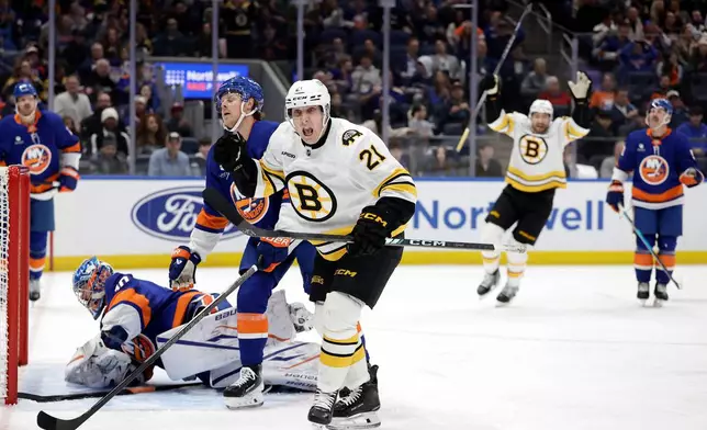 Boston Bruins center Alex Steeves reacts after scoring a goal past New York Islanders goaltender Ilya Sorokin in the first period of an NHL hockey game, Wednesday, Nov. 26, 2025, in Elmont, N.Y. (AP Photo/Adam Hunger)