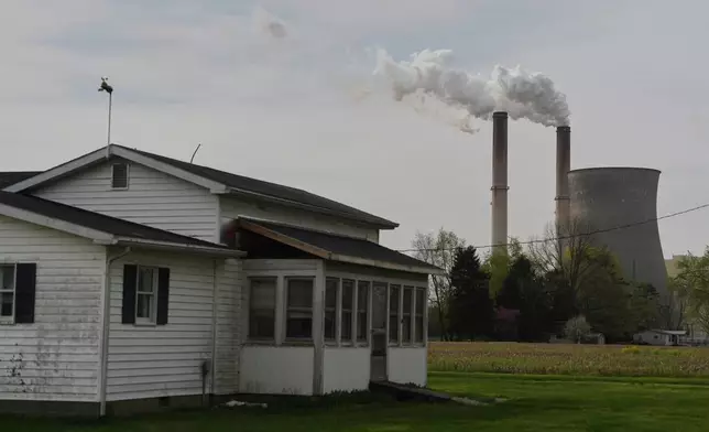 FILE - A home sits near the Gen. James Gavin Power Plant, a coal-fired power plant, April 14, 2025, in Cheshire, Ohio. (AP Photo/Joshua A. Bickel, File)