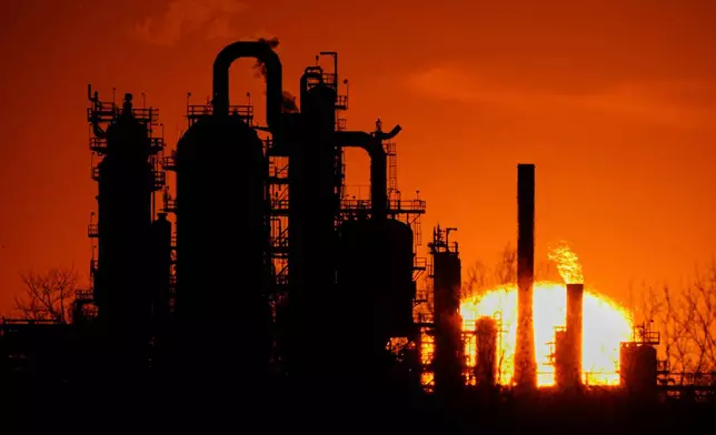 FILE - The HF Sinclair El Dorado oil refinery is silhouetted against the sky at sunset March 21, 2025, in El Dorado, Kan. (AP Photo/Charlie Riedel, File)