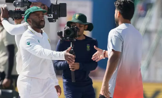 India's captain Rishab Pant, right, and South Africa's captain Temba Bavuma shake hands after South Africa wins the test series against India in Guwahati, India, Saturday, Nov. 22, 2025. (AP Photo/Anupam Nath)