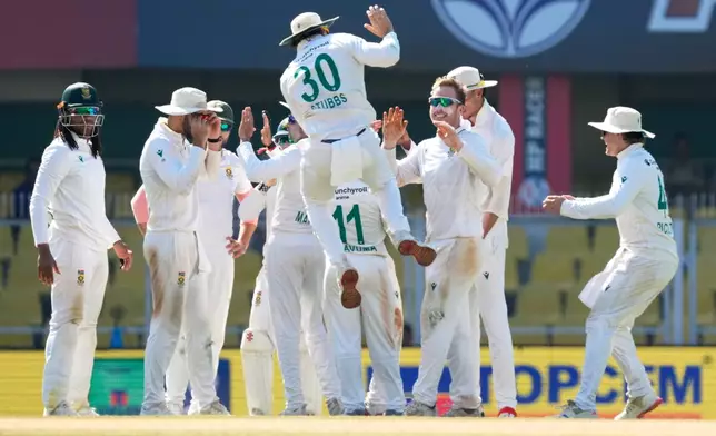 South Africa's players celebrate the dismissal of India's Washington Sundar on the fifth day of the second cricket test match between India and South Africa in Guwahati, India, Saturday, Nov. 22, 2025. (AP Photo/Anupam Nath)
