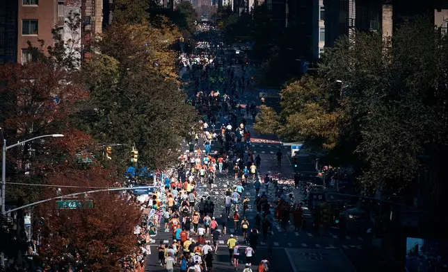 Runners move along First Avenue during the New York City Marathon in New York, Sunday, Nov. 2, 2025. (AP Photo/Andres Kudacki)