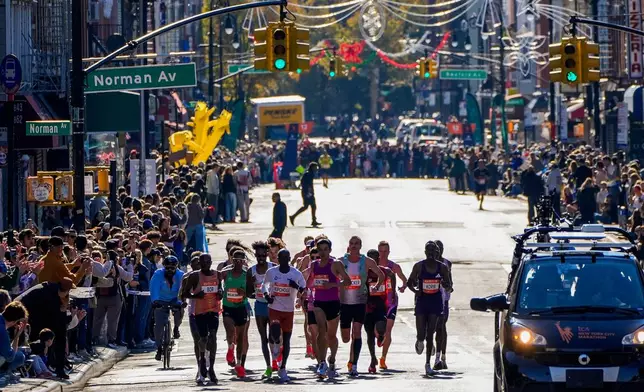 Athletes in the men's elite division make their way through Brooklyn during the New York City Marathon, Sunday, Nov. 2, 2025, in New York. (AP Photo/Yuki Iwamura)