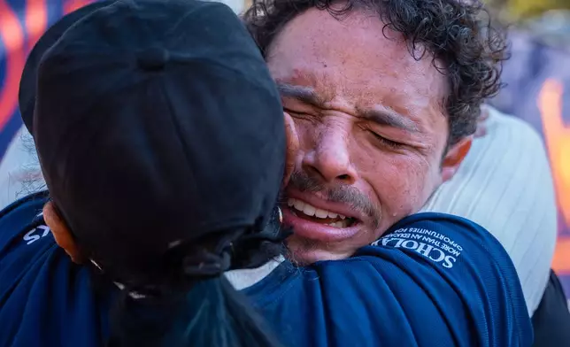 Broadway actor Anthony Ramos cries into his mother Mildred's arms after crossing the finish line of the New York City Marathon, Sunday, Nov. 2, 2025, in New York. (AP Photo/Angelina Katsanis)