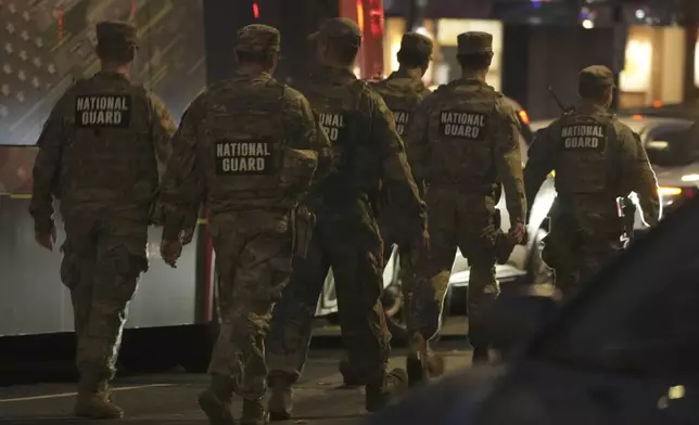 Nation Guard move through the area following the shooting of two National Guard soldiers near the White House Wednesday, Nov. 26, 2025, in Washington. (AP Photo/Mark Schiefelbein)