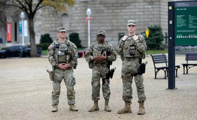 National Guard patrol on the National Mall near the U.S. Capitol, Wednesday, Nov. 26, 2025, in Washington. (AP Photo/Rahmat Gul)
