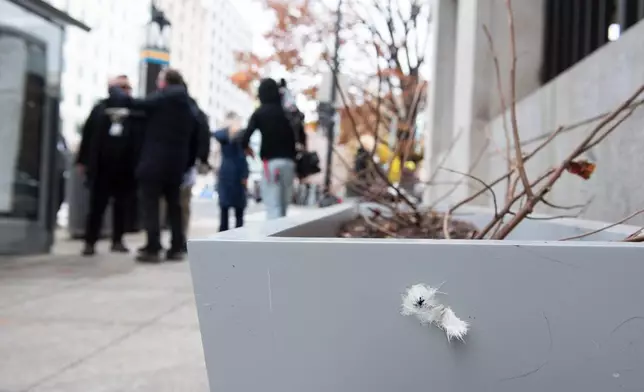 What appears to be a bullet hole in a sidewalk planter at the scene a day after two National Guard soldiers were shot near the White House in Washington, Thursday, Nov. 27, 2025. (AP Photo/Cliff Owen)