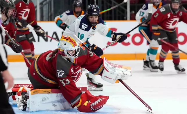 Ottawa Charge goaltender Gwyneth Philips (33) tries to make a save during the second period of a PWHL hockey game against the New York Sirens in Ottawa, Ontario, Saturday, Nov. 22, 2025. (Justin Tang/The Canadian Press via AP)