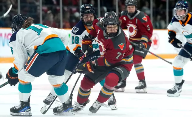Ottawa Charge's Fanuza Kadirova (71) looks for the puck past New York Sirens' Lauren Bernard (16) during first period PWHL hockey action in Ottawa, on Saturday, Nov. 22, 2025. (Justin Tang/The Canadian Press via AP)