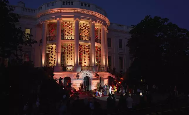President Donald Trump and first lady Melania Trump greet families during a Halloween event on the South Lawn of the White House, Thursday, Oct. 30, 2025, in Washington. (AP Photo/Jacquelyn Martin)