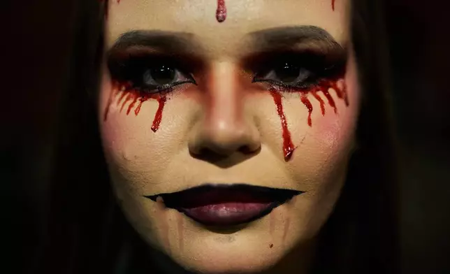 A girl dressed up in scary costume takes part in a Halloween party in Berlin, Friday, Oct. 31, 2025. (AP Photo/Ebrahim Noroozi)