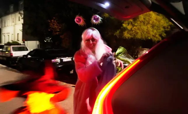 Young people dressed for a Halloween party in Warsaw, Poland, Friday, Oct. 31, 2025. (AP Photo/Czarek Sokolowski)