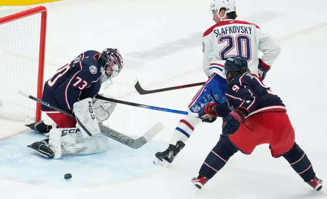 Columbus Blue Jackets goaltender Jet Greaves (73) blocks a shot by Montreal Canadiens left wing Juraj Slafkovsky (20) in the first period of an NHL hockey game in Columbus, Monday, Nov. 17, 2025. (AP Photo/Sue Ogrocki)