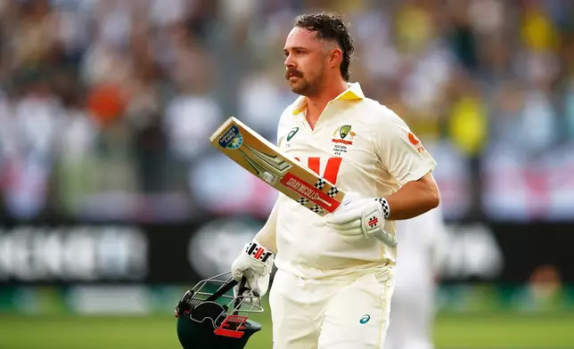 Australia's Travis Head leaves the field after losing his wicket on day two of the first Ashes cricket test match between Australia and England in Perth, Saturday, Nov. 22, 2025.(AP Photo/Gary Day)