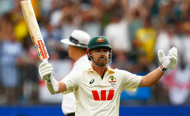 Australia's Travis Head celebrates his century on day two of the first Ashes cricket test match between Australia and England in Perth, Saturday, Nov. 22, 2025.(AP Photo/Gary Day)