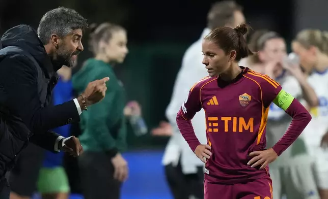 Roma's head coach Luca Rossettini, left, talks to Manuela Giugliano during the women's Champions League soccer match between Roma and Valerenga, in Rome, Tuesday, Nov. 11, 2025. (Alfredo Falcone/LaPresse via AP)