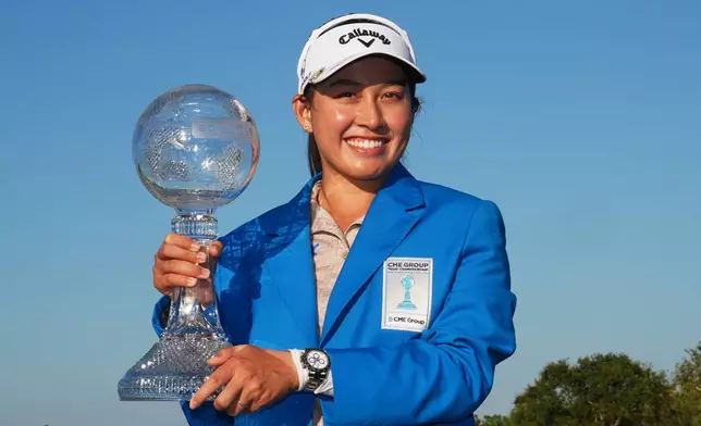 Jeeno Thitikul of Thailand holds the CME Global Trophy after winning the LPGA Tour Championship golf tournament, Sunday, Nov. 23, 2025, in Naples, Fla. (AP Photo/Marta Lavandier)