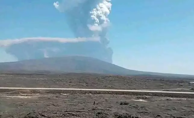 In this photo released by the Afar Government Communication Bureau, ash billows from the first time eruption of the Hayli Gubbi Volcano in Ethiopia's Afar region Sunday, Nov. 23, 2025. (Afar Government Communication Bureau via AP)
