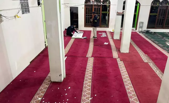 Members of Indonesian Police bomb squad inspect the mosque where explosions went off at a high school compound in Jakarta, Indonesia, Friday, Nov. 7, 2025. (AP Photo/Fadlan Syam)