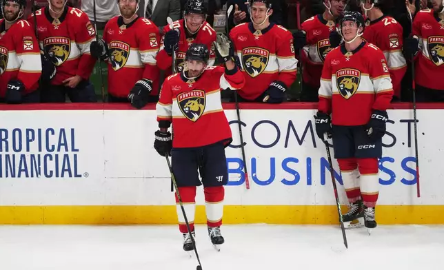 Florida Panthers left wing Brad Marchand (63) acknowledges the cheers from the crowd after reaching 1,000 career points during the third period of an NHL hockey game against the Washington Capitals, Thursday, Nov. 13, 2025, in Sunrise, Fla. (AP Photo/Marta Lavandier)