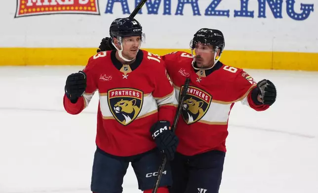 Florida Panthers center Sam Reinhart (13) celebrates his goal with left wing Brad Marchand (63) during the second period of an NHL hockey game against the Washington Capitals, Thursday, Nov. 13, 2025, in Sunrise, Fla. (AP Photo/Marta Lavandier)