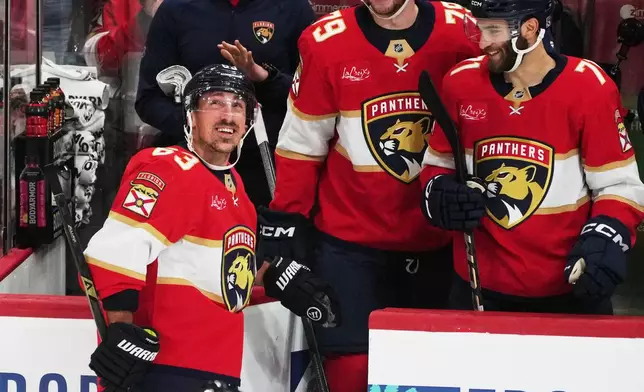 Florida Panthers left wing Brad Marchand (63) acknowledges the cheers from the crowd after reaching 1,000 career points during the third period of an NHL hockey game against the Washington Capitals, Thursday, Nov. 13, 2025, in Sunrise, Fla. (AP Photo/Marta Lavandier)