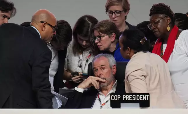 André Corrêa do Lago, COP30 president, sits as Simon Stiell, United Nations climate chief, left, speaks with other U.N. officials during a plenary session at the COP30 U.N. Climate Summit, Saturday, Nov. 22, 2025, in Belem, Brazil. (AP Photo/Andre Penner)