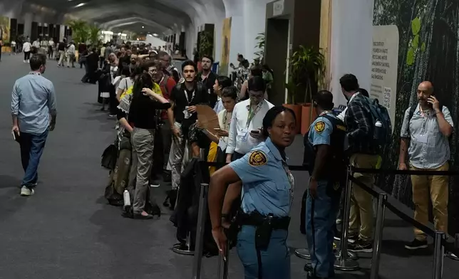 Attendees line up to enter a hall for a plenary session at the COP30 U.N. Climate Summit, Saturday, Nov. 22, 2025, in Belem, Brazil. (AP Photo/Fernando Llano)