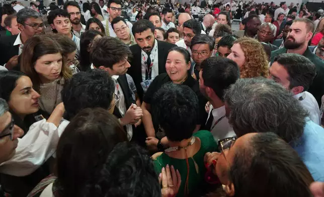 Ana Aguilar, operative director at the ministry of environment of Panama, center, speaks surrounded by delegates at a plenary session during the COP30 U.N. Climate Summit, Saturday, Nov. 22, 2025, in Belem, Brazil. (AP Photo/Andre Penner)